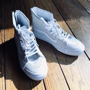 Women’s Sk8-hi white leather vans.